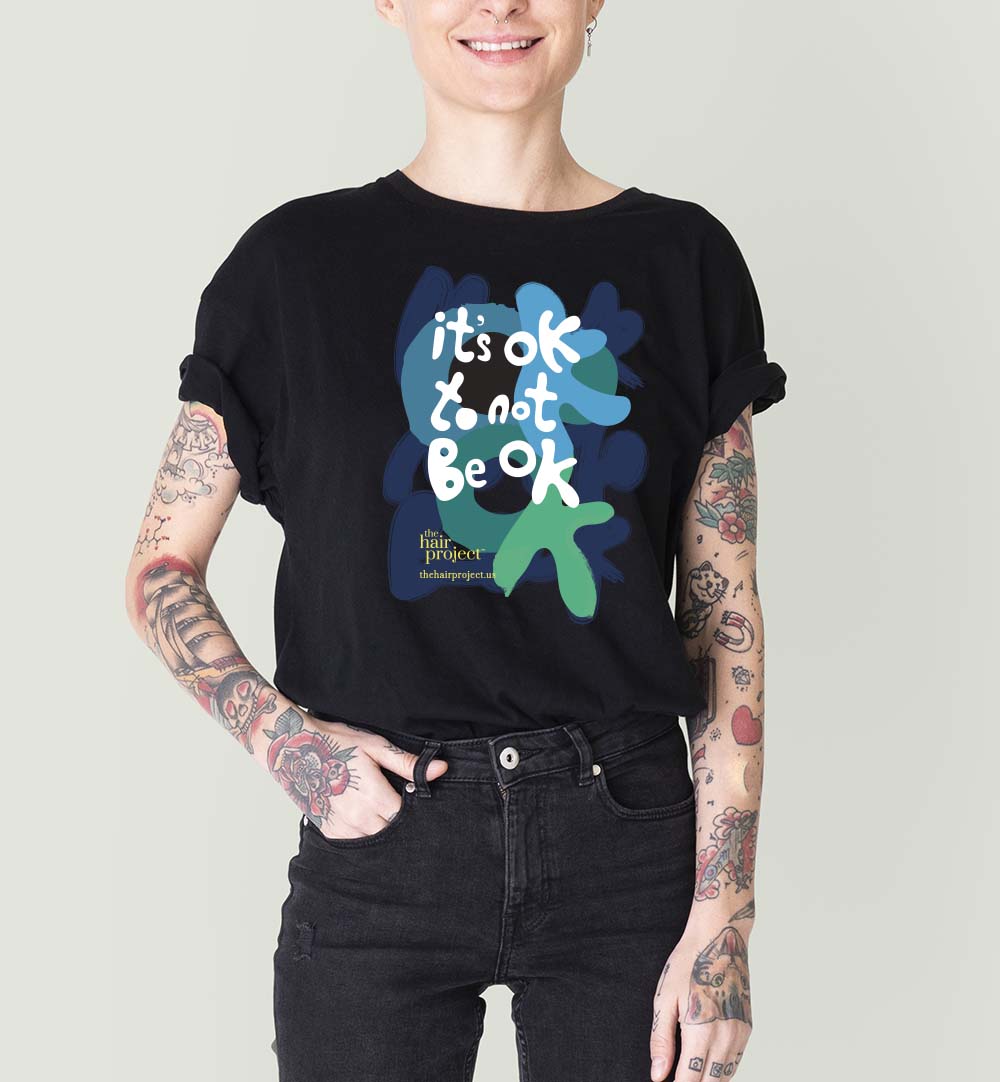 Model with tattoo in black T shirt and jeans